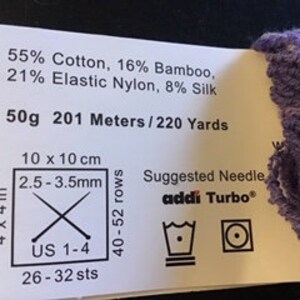 May include: Yarn label with purple yarn skein. The label shows the yarn composition: 55% Cotton, 16% Bamboo, 21% Elastic Nylon, 8% Silk. It also shows the weight: 50g, the length: 201 Meters/220 Yards, and the suggested needle size: US 1-4 (2.5-3.5mm).