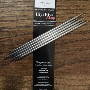 May include: A set of six silver double-pointed knitting needles, HiyaHiya Sharp brand, size US 6/4mm, 6 inches long. The needles are made of stainless steel and are lightweight, smooth, and have a point perfection. The packaging includes the brand name, size, and information about the manufacturer, Shanghai Hiya Co., Ltd.