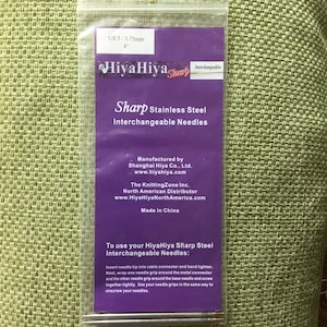 May include: Purple and white packaging for HiyaHiya Sharp Stainless Steel Interchangeable Needles, size US 5/3.75mm, 4 inches. The packaging includes instructions on how to use the needles.
