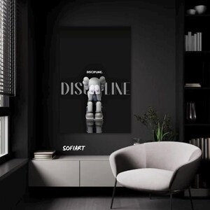 May include: A black wall art print with a gray figure made of stacked shapes, and the word "DISCIPLINE" in large, stylized letters. The word "DISCIPLINE" is also written above the figure. The print is displayed in a modern, minimalist interior.