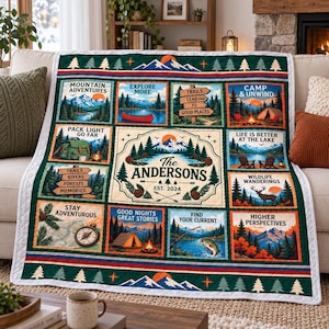 May include: A rectangular quilt featuring a grid of outdoor-themed illustrations including mountains, forests, a canoe, a tent, a campfire, a deer, and a compass. The center panel displays the text The Andersons EST. 2024 with pine trees and mountains.