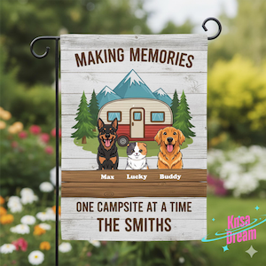 May include: A garden flag with a camping theme, featuring a camper, mountains, and three cartoon pets. Text includes "MAKING MEMORIES", "ONE CAMPSITE AT A TIME", and a family name. The background has a wood-grain design.