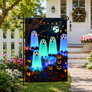 May include: A rectangular garden flag featuring a Halloween scene with four glowing blue and white ghosts, a stack of three orange jack-o'-lanterns, a dark tree, a full moon with bats, and a silhouette of a house under string lights.