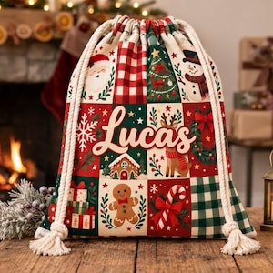 Könnte beinhalten: Ein Geschenksack mit Kordelzug und festlichem Patchwork-Design, das den Weihnachtsmann, einen Schneemann, einen Lebkuchenmann, ein Rentier, einen Weihnachtsbaum und Geschenke zeigt. Der Name Lucas steht in großer weißer Schrift mittig.