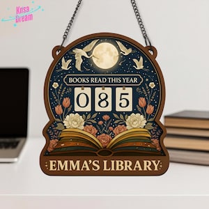 May include: Wooden sign with a dark blue background, featuring a full moon, cranes, and floral accents. The sign reads "BOOKS READ THIS YEAR" above the number "085". The bottom of the sign says "EMMA'S LIBRARY". A chain is attached for hanging.