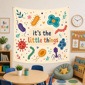 May include: A cream-colored wall tapestry featuring colorful illustrations of various microorganisms and bacteria, with the text "it's the little things" printed in the center in dark blue and orange lettering, surrounded by small decorative shapes.