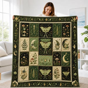May include: A rectangular quilt featuring a grid of panels with botanical and celestial illustrations. The design includes green moths, crescent moons, stars, ferns, and mushrooms in shades of dark green, cream, and sage on a quilted fabric.