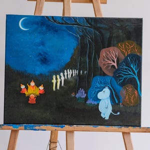 May include: A canvas painting of a night-time forest scene with a blue character, a campfire, and a line of glowing figures under a crescent moon. The artwork uses blues, oranges, and greens. The painting is displayed on a wooden easel.