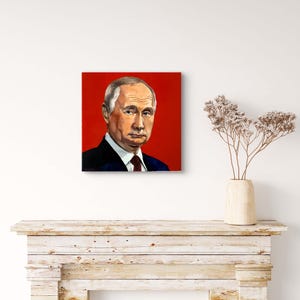 May include: A portrait painting of a man with grey hair, wearing a black suit and a red tie, set against a vibrant red background. The artwork is displayed on a white wall.