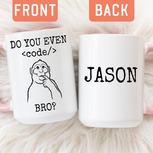 May include: Two white ceramic mugs with light pink handles. The left mug features a black line drawing of a monkey with the text DO YOU EVEN <code> BRO? The right mug displays the name JASON in black capital letters on the front.
