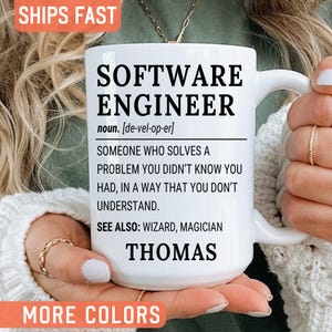 May include: A white ceramic mug featuring black text that reads SOFTWARE ENGINEER noun. [de-vel-op-er] SOMEONE WHO SOLVES A PROBLEM YOU DIDN'T KNOW YOU HAD, IN A WAY THAT YOU DON'T UNDERSTAND. SEE ALSO: WIZARD, MAGICIAN THOMAS. The mug has a handle on the right side.