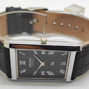 May include: A set of three ceramic mugs with a speckled, matte finish. The mugs are in shades of cream, light gray, and dark gray. Each mug has a simple, minimalist design, perfect for coffee or tea.