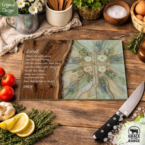 May include: A rectangular glass cutting board featuring a wood grain pattern on the left side with the text Lord, Bless her with peace and strength today, Fill her home with Your love and her heart with Your joy, Guide her steps, calm her worries, and remind her how deeply she is loved, AMEN. The right side displays a cross design with floral accents.