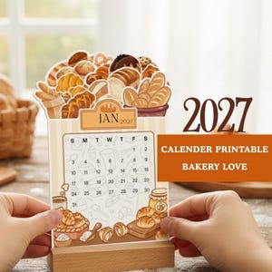 May include: A 2027 desk calendar featuring a bakery theme with illustrations of various breads and pastries at the top. The calendar page shows the month of January with a grid of dates and small baking-related icons on a light striped background.