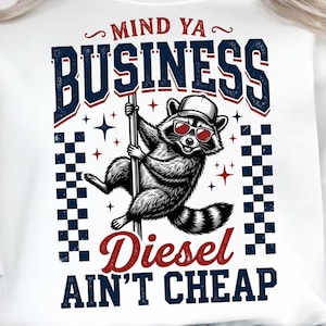 May include: A white sweatshirt featuring a graphic of a raccoon wearing a baseball cap and red sunglasses while climbing a pole. The text reads MIND YA BUSINESS and DIESEL AIN'T CHEAP in blue and red, flanked by vertical blue and white checkered borders.