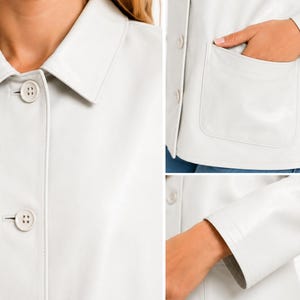 May include: A white jacket with a collar and button closure. The jacket has a pocket on the front and long sleeves. The jacket is made of a smooth material. The jacket is a light cream color.