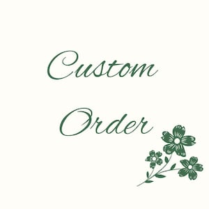 May include: Cream-colored background with the words "Custom Order" in dark green script. A floral sprig with three flowers and leaves is in the lower right corner, also in dark green.