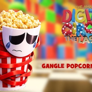 May include: A popcorn bucket filled with popcorn, wrapped in red ribbons, and featuring a sad face design. The text "GANGLE POPCORN BUCKET" is displayed at the bottom of the image. The background features the text "THE AMAZING DIGITAL CIRCUS THE LAST ACT".