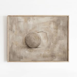 May include: Abstract framed artwork featuring a large, textured sphere emerging from a neutral-toned background. The painting has a muted color palette of beige and gray, with subtle drips and a weathered appearance. The wooden frame adds a rustic touch.