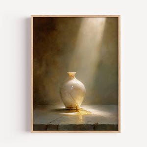 Pode incluir: Uma impressão artística emoldurada com uma natureza morta de um vaso rachado, esbranquiçado. O vaso está sobre uma superfície de pedra, iluminado por um raio de luz. A obra de arte tem uma paleta de cores quentes e suaves.