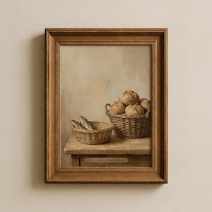 May include: A framed painting depicts a still life with two woven baskets. One basket holds several round loaves of bread, and the other contains a few fish. The painting is set on a wooden table against a neutral background.
