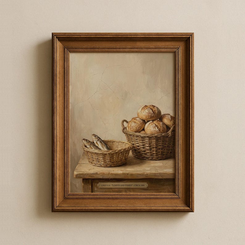 May include: A framed painting depicts a still life with two woven baskets. One basket holds several round loaves of bread, and the other contains a few fish. The painting is set on a wooden table against a neutral background.