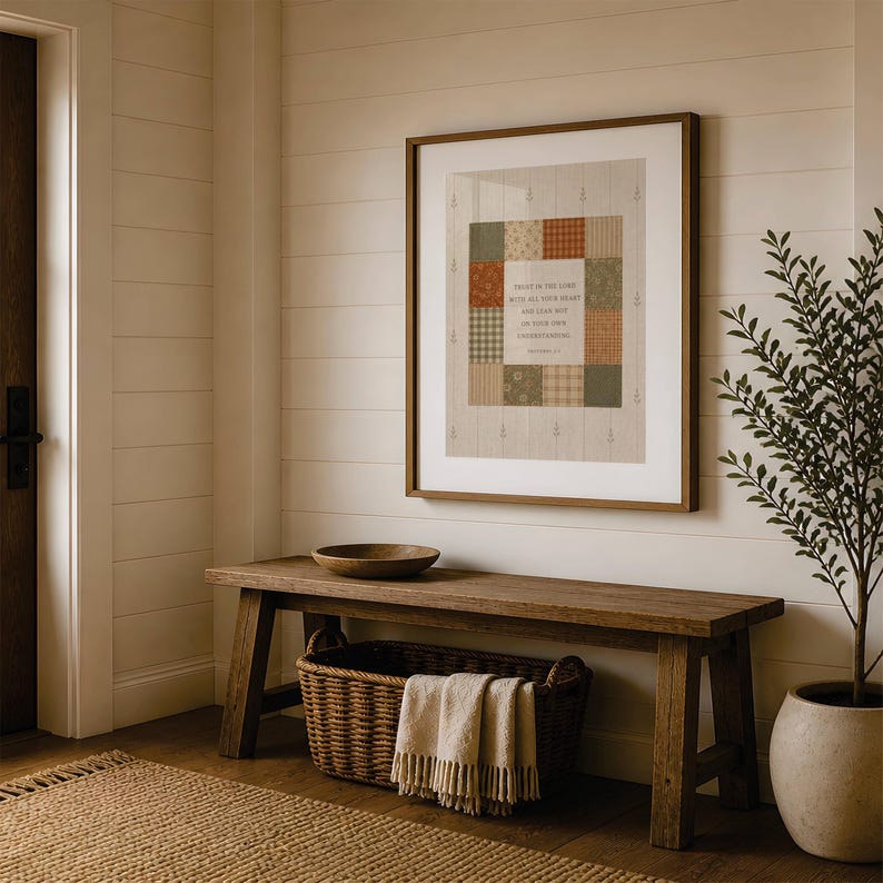 May include: A framed wall art print featuring a patchwork quilt design in muted earth tones of green, orange, and cream. The center square contains the text: Trust in the Lord with all your heart and lean not on your own understanding. Proverbs 3:5.