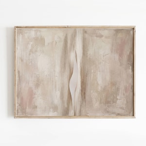May include: Abstract art print in a rectangular wooden frame. The artwork features a neutral color palette with beige, tan, and pink tones. A vertical, curved white shape bisects the center of the painting, creating a sense of depth and texture.
