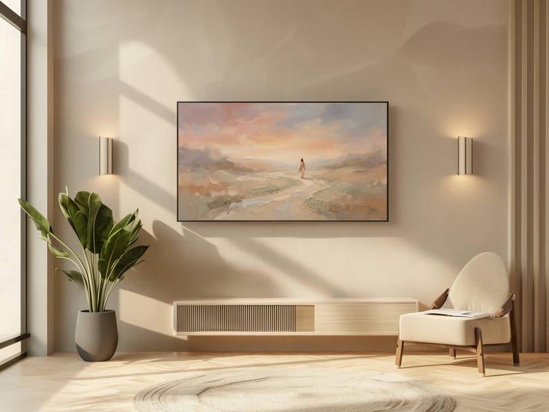 K&ouml;nnte beinhalten: Ein abstraktes Landschaftsgem&auml;lde in einem schwarzen Rahmen h&auml;ngt an einer beigen Wand. Das Kunstwerk zeigt eine Figur, die auf einem Weg auf einen farbenfrohen Sonnenuntergang zugeht. Darunter ein moderner, heller Holzschrank und ein Stuhl mit cremefarbenem Kissen.