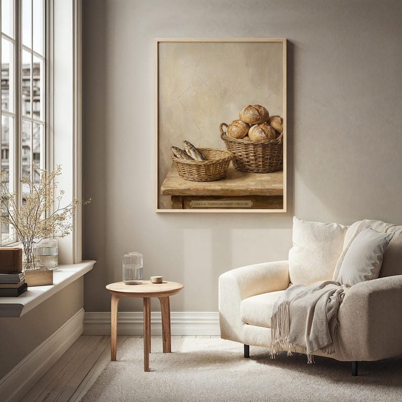 May include: A framed painting depicts a still life with two woven baskets on a wooden table. One basket holds several round loaves of bread, and the other contains fish. The painting has a neutral color palette with warm tones.