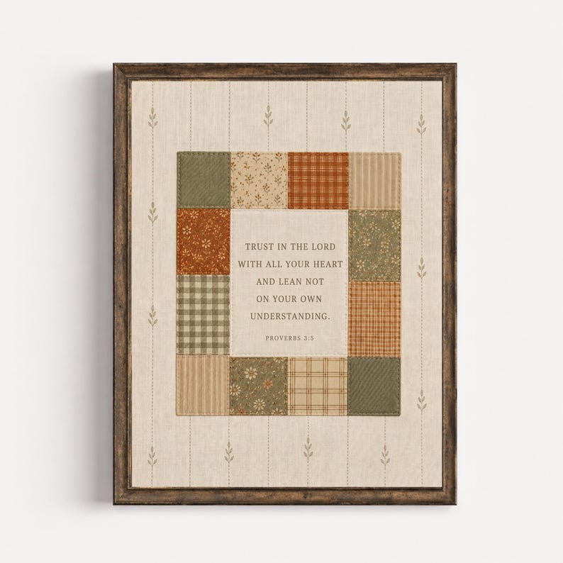 May include: A framed wall art piece featuring a central cream-colored panel with the text "TRUST IN THE LORD WITH ALL YOUR HEART AND LEAN NOT ON YOUR OWN UNDERSTANDING. PROVERBS 3:5" surrounded by a border of assorted fabric squares in earth tones.