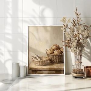 May include: A framed print depicting a still life with two wicker baskets. One basket holds several round loaves of bread, and the other contains fish. The print is set on a wooden table against a neutral background. The text on the print reads "Luke 9:16 'Loaves and Fishes' Circa 1880."
