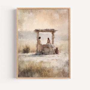 May include: A framed wall art print featuring a watercolour-style painting of two figures in tan robes standing by a stone well in a dry, grassy landscape. The scene is rendered in soft, muted earth tones with a light, hazy sky in the background.