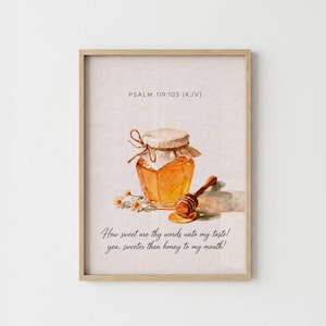 May include: A framed wall art print featuring a watercolour illustration of a honey jar with a wooden dipper and small white flowers. The text reads PSALM 119:103 (KJV) and How sweet are thy words unto my taste! yea, sweeter than honey to my mouth!