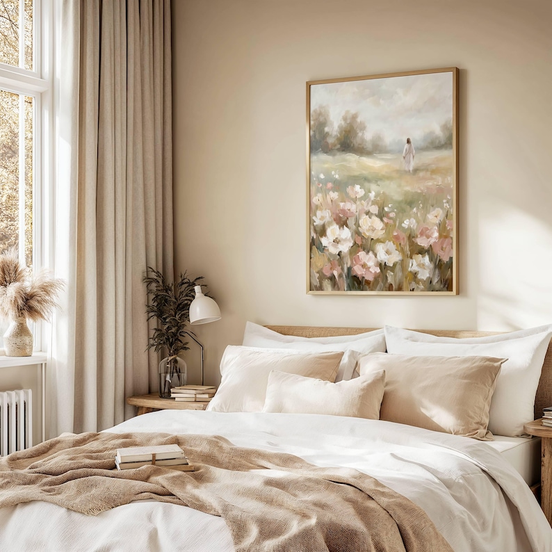 May include: A bedroom scene featuring a bed with white linens and beige pillows and throw. A framed painting of a field of flowers hangs above the bed. The room has beige curtains and a small table with a lamp.