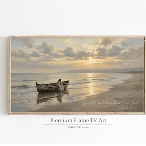 May include: A framed print of a serene beach scene with a wooden boat and a figure seated inside. The artwork features a warm color palette of beige, gold, and blue, with text that reads "Be still, and know that I am God. Psalm 46:10."