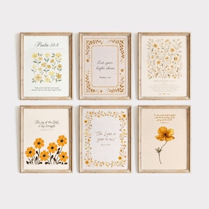 May include: A set of six rectangular wall art prints in light wood frames, each featuring floral illustrations and religious text. The prints include verses such as Psalm 34:8, Let your light shine, Philippians 4:6-7, The joy of the Lord, The Lord is good to all, and Habakkuk 2:14.