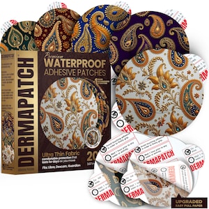 Op de afbeelding: Een doos DERMAPATCH waterdichte zelfklevende pleisters met een paisley-ontwerp. De doos en pleisters hebben goud, bruin, blauw en paars. De pleisters hebben een diameter van 7,8 cm en zijn ontworpen voor comfort en langdurig gebruik.