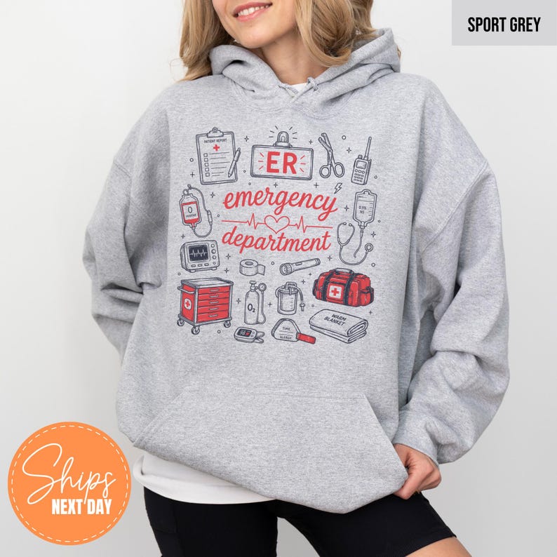May include: A sport grey hooded sweatshirt featuring a graphic print of medical equipment and the text ER emergency department. The design includes illustrations of a clipboard, scissors, walkie-talkie, IV bag, monitor, flashlight, and medical cart.