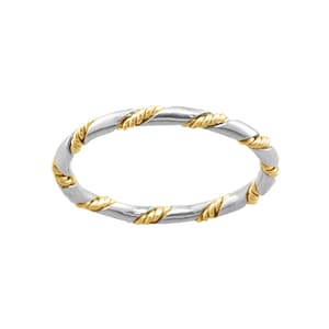May include: A silver and gold ring with a twisted design. The ring is made of two metals, one silver and one gold, that are twisted together to create a unique look.