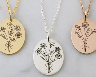 May include: Three necklaces with round pendants featuring a delicate line drawing of a bouquet of flowers. The pendants are gold, silver, and rose gold.