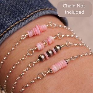 May include: Three bracelets with pink shell beads and silver accents. The bracelets are layered on a person's wrist. "Chain Not Included" is written in the top right corner of the image.