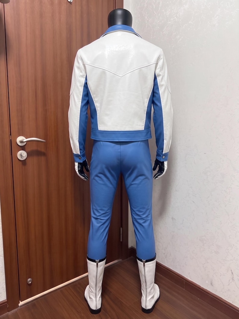 May include: A costume set consisting of a white and blue jacket with a pointed back yoke, matching blue trousers, black gloves, and white mid-calf boots with rear zippers. The ensemble features a color-blocked design with white sleeves and back panel.