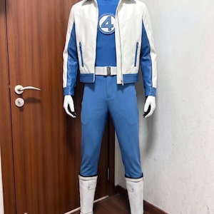 May include: A blue jumpsuit with a mock neck and a circular emblem featuring the number 4 on the chest. It is worn with a white and blue jacket, a white belt, white gloves, and white boots. The outfit is displayed on a mannequin.