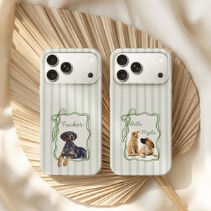 May include: Two smartphone cases featuring a light green and white vertical striped pattern. Each case displays a green outlined frame with a bow, containing custom pet portraits and names. One case shows a dog named Tucker, the other shows a cat named Bella and a dog named Mylo.