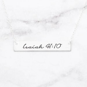 May include: A silver necklace with a bar pendant that says "Isaiah 41:10" in cursive script.