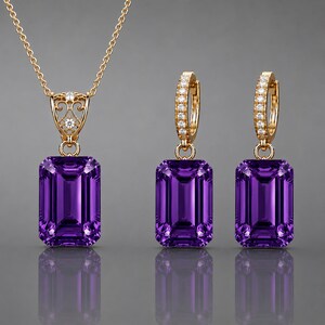 May include: A jewelry set consisting of a gold necklace and a pair of matching gold hoop earrings. Each piece features a large, rectangular, deep purple amethyst gemstone. The necklace bail and earring hoops are accented with small, clear, round stones.