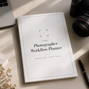 May include: A flat lay featuring a laptop, a Canon EOS 5D camera, a coffee mug, a pen, and a book titled "The Photographer Workflow Planner." The planner's cover has a minimalist design with a camera lens icon.