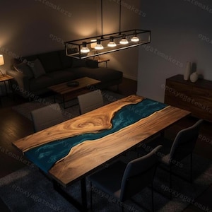 May include: A large wooden dining table with a blue epoxy river design. The table is rectangular, with a dark wood grain and a glossy blue center. The table is 96 inches long and 40 inches wide.