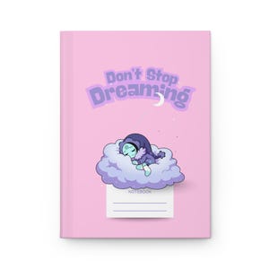 May include: A pink notebook with the words "Don't Stop Dreaming" in purple. A cartoon character sleeps on a cloud. The word "Notebook" is at the bottom with lines for writing.